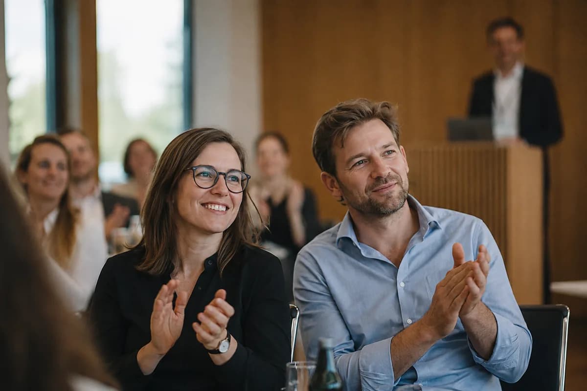 Guests applauding a speaker at a corporate event